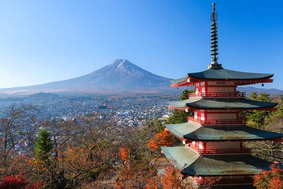 Mount Fuji and a red five-story pagoda above a cityscape on a clear autumn day